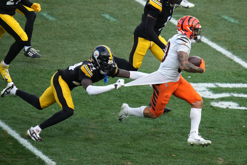 Pittsburgh Steelers cornerback Joey Porter Jr. (24) tries to tackle Cincinnati Bengals running back Chase Brown (30) during the second half of an NFL football game Sunday, Nov. 16, 2025, in Pittsburgh. (AP Photo/Gene J. Puskar)