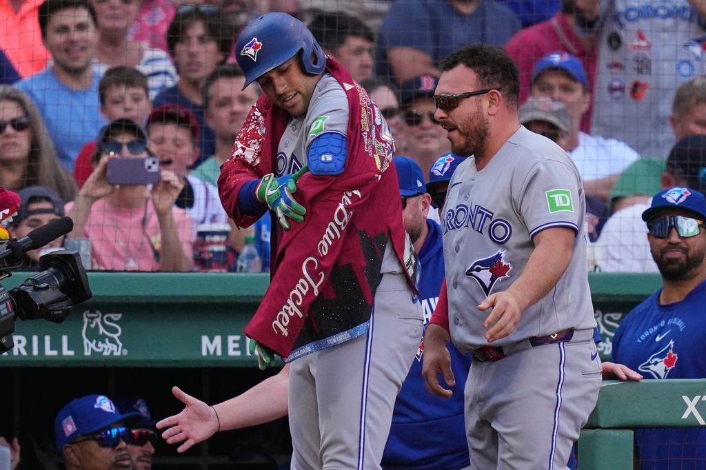 Toronto Blue Jays' George Springer celebrates after his three-run home run during the third inning of a baseball game against the Boston Red Sox, Saturday, July 25, 2026, in Boston. (AP Photo/Charles Krupa)