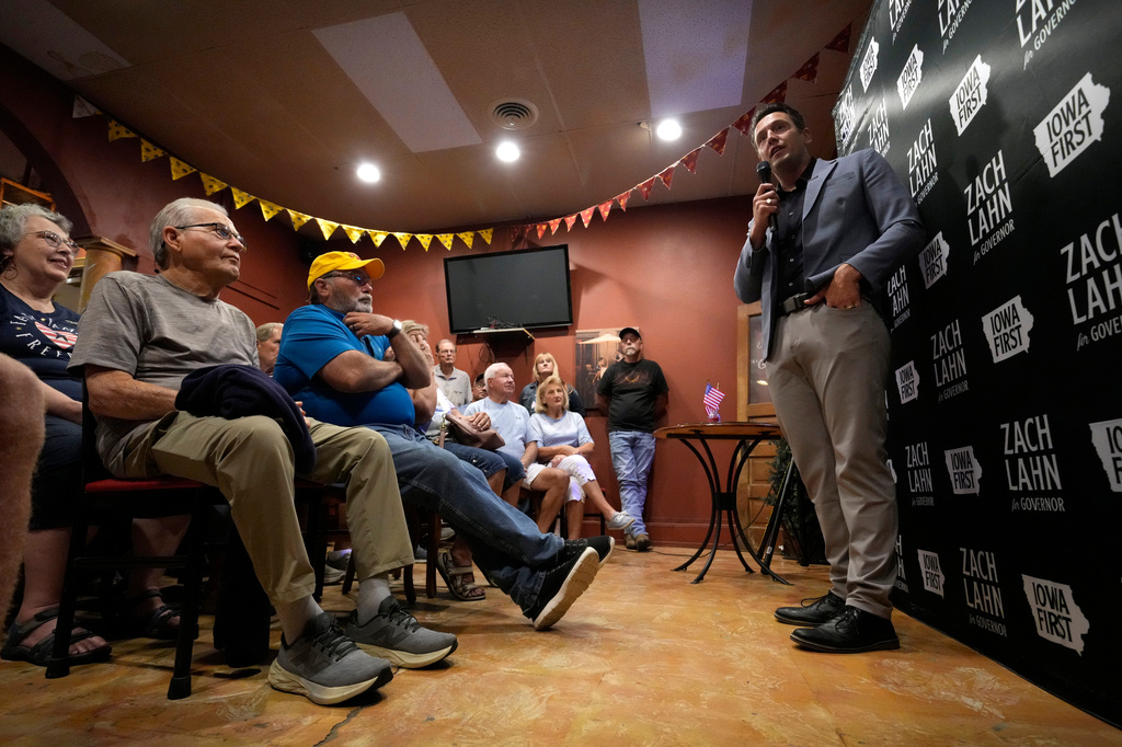 Zach Lahn, Republican candidate for Iowa governor, speaks to local residents during a meet and greet, Tuesday, Aug. 4, 2026, in Hampton, Iowa. (AP Photo/Charlie Neibergall)