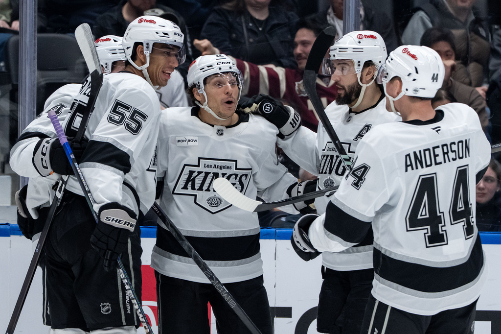 Los Angeles Kings' Trevor Moore, center, celebrates after his goal against the Vancouver Canucks with Quinton Byfield (55), Alex Laferriere,back left, Drew Doughty, second from right, and Mikey Anderson (44) during the second period of an NHL hockey game in Vancouver, British Columbia, Thursday, March 26, 2026. (Ethan Cairns/The Canadian Press via AP)