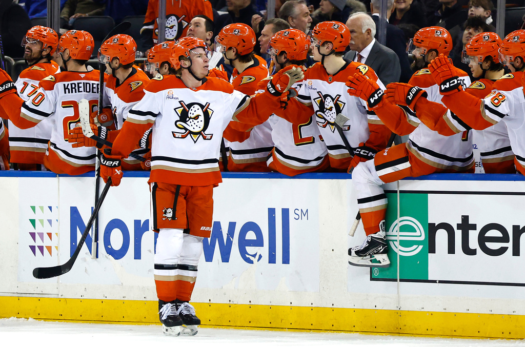 Anaheim Ducks defenseman Jackson Lacombe, front, celebrates with teammates after scoring against the New York Rangers during the second period of an NHL hockey game Monday, Dec 15, 2025, in New York. (AP Photo/Noah K. Murray)