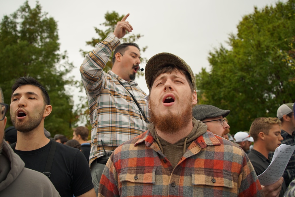 Attendees sing hymns in front of the town hall during Pride Fest in Wake Forest, N.C., on Saturday, Oct. 11, 2025. The LGBTQ+ festival coincided with National Coming Out Day. (AP Photo/Allen G. Breed)
