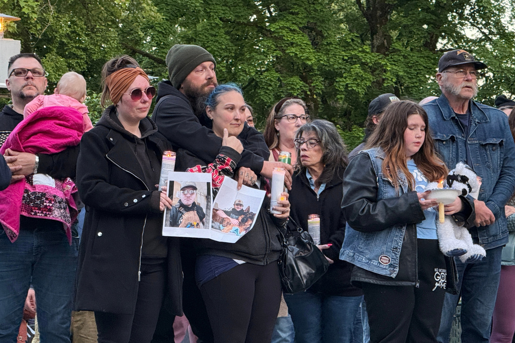 People gather at a vigil after a chemical tank failure at a paper mill killed at least one worker and left others unaccounted for in Longview, Wash., Tuesday, May 26, 2026. (AP Photo/Claire Rush)