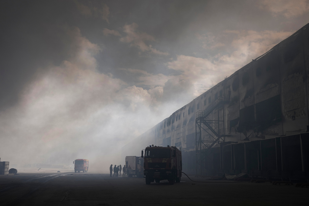 Smoke rises above warehouse stores after a Russian air attack in Kyiv, Ukraine, Thursday, Aug. 27, 2026. (AP Photo/Efrem Lukatsky)