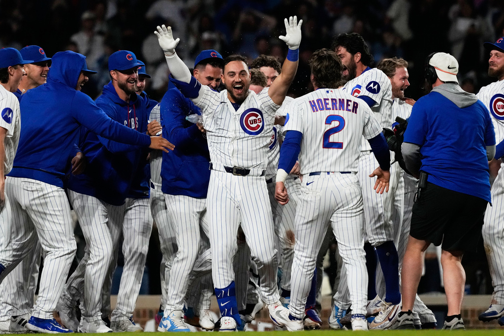 Chicago Cubs' Michael Conforto, center, celebrates with teammates after hitting the winning solo home run during the ninth inning of a baseball game against the Cincinnati Reds in Chicago, Monday, May 4, 2026. (AP Photo/Nam Y. Huh)