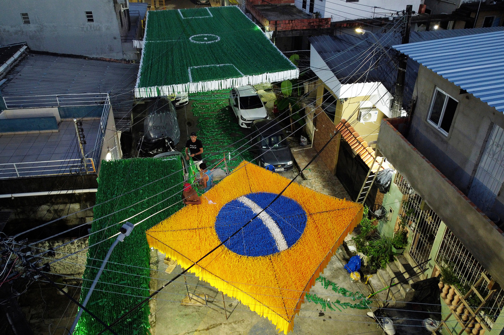 Residents set up decorations ahead of the 2026 FIFA World Cup, in Manaus, Brazil, Sunday, May 17, 2026. (AP Photo/Edmar Barros)