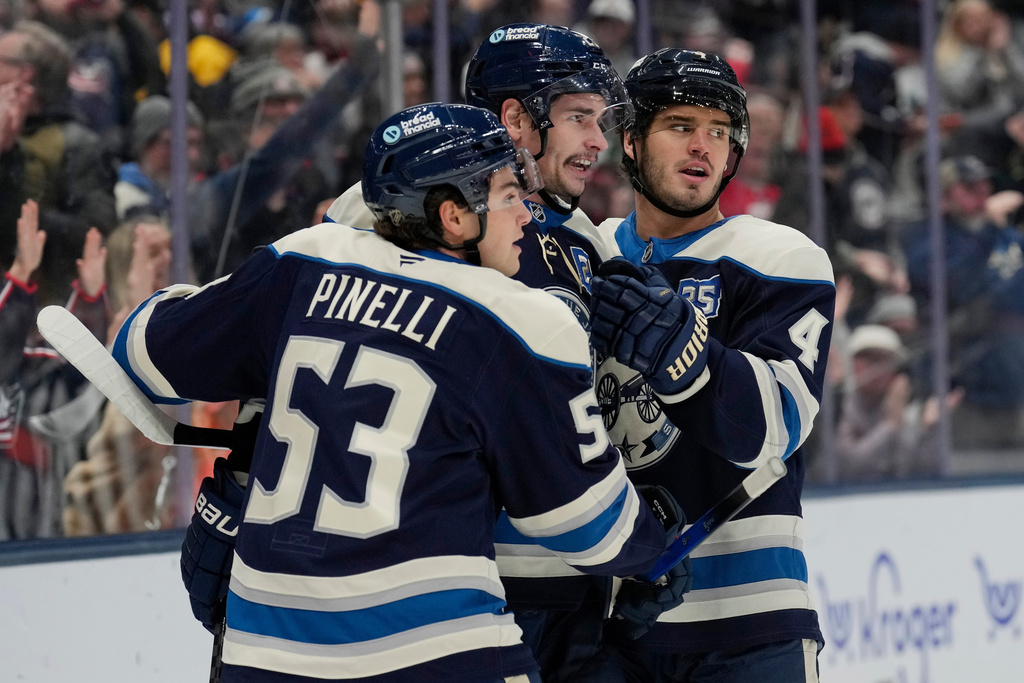 From left, to right Columbus Blue Jackets centers Luca Pinelli, Sean Monahan and Cole Sillinger celebrate after Monahan's goal during the first period of an NHL hockey game against the Pittsburgh Penguins, Friday, Nov. 28, 2025, in Columbus, Ohio. (AP Photo/Carolyn Kaster)