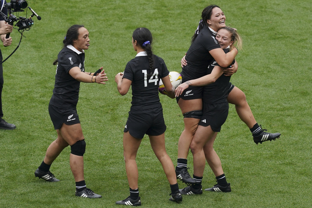 New Zealand's Renee Holmes, right, celebrates scoring their side's 3rd try of the game a try during the Women's Rugby World Cup bronze match between New Zealand and France at the Allianz Stadium, Twickenham, London, Saturday, Sept. 27, 2025. (Gareth Fuller/PA via AP)