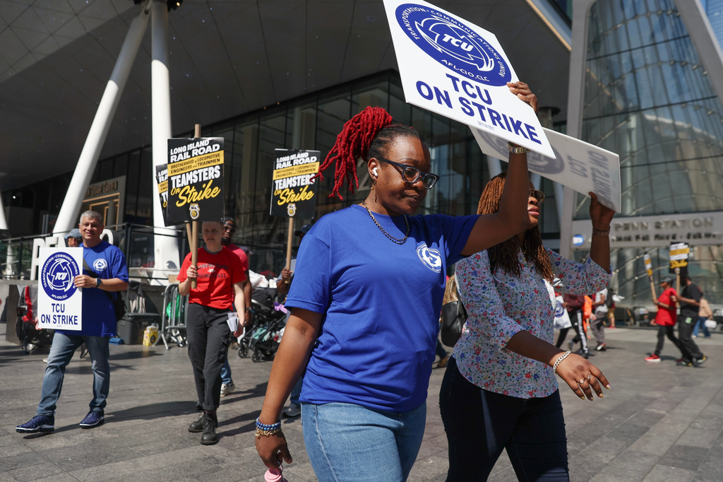 Long Island Rail Road workers walk on the picket line outside of Penn Station on the third day of their strike, Monday, May 18, 2026, in New York. (AP Photo/Heather Khalifa)