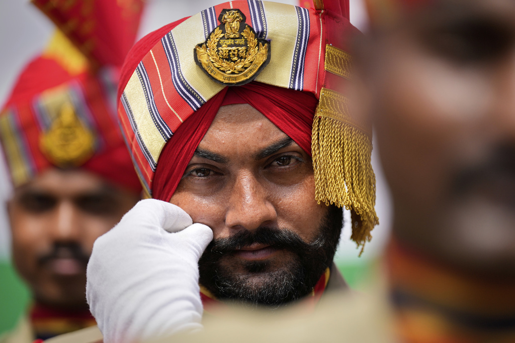 A Sikh paramilitary person adjusts his moustache before taking part in a parade during the country's Independence Day celebrations in Guwahati, India, Friday, Aug. 15, 2025. (AP Photo/Anupam Nath)