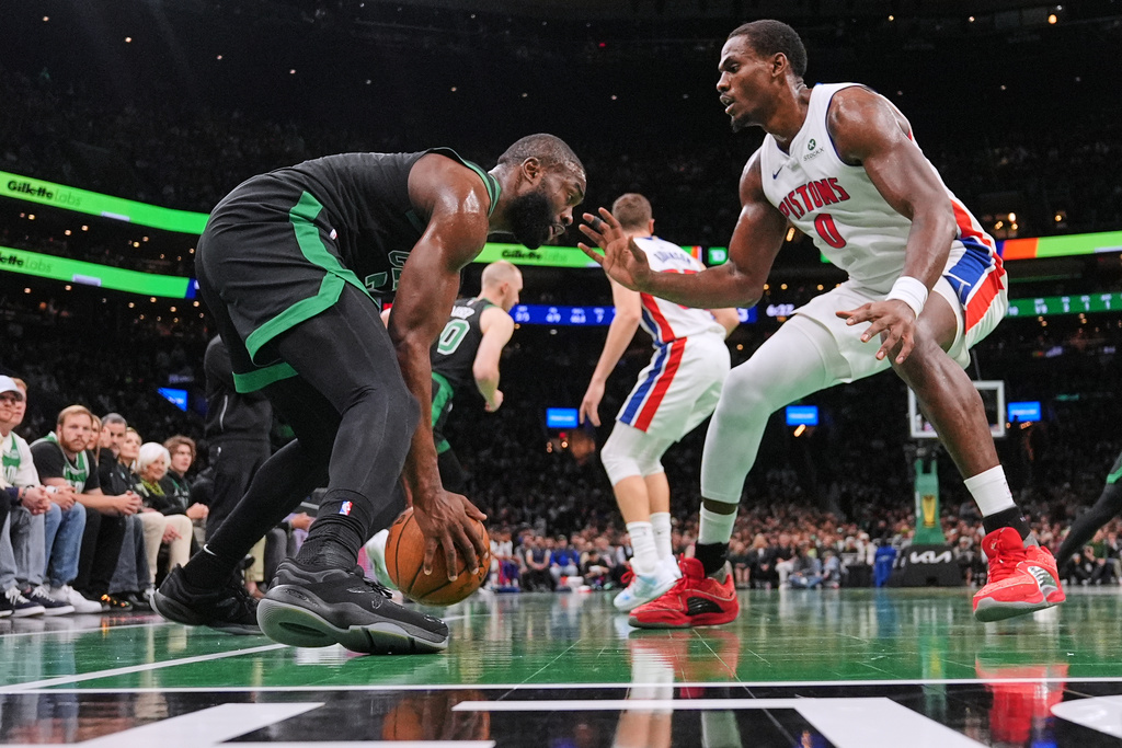 Boston Celtics guard Jaylen Brown, left, sets to drive against Detroit Pistons center Jalen Duren (0) during the first half of an Emirates NBA Cup basketball game, Wednesday, Nov. 26, 2025, in Boston. (AP Photo/Charles Krupa)