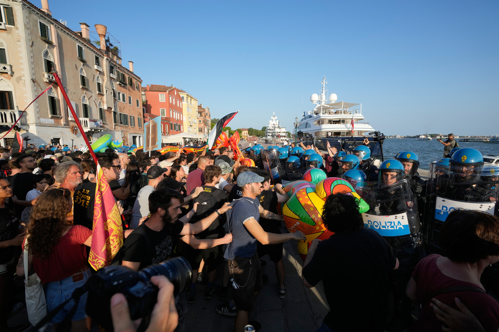 Police officers confront demonstrators gathered to protest against U.S. Ambassador Tilman Fertitta's superyacht 'Boardwall' presence in Venice, Friday, July 17, 2026. (AP Photo/Luca Bruno)