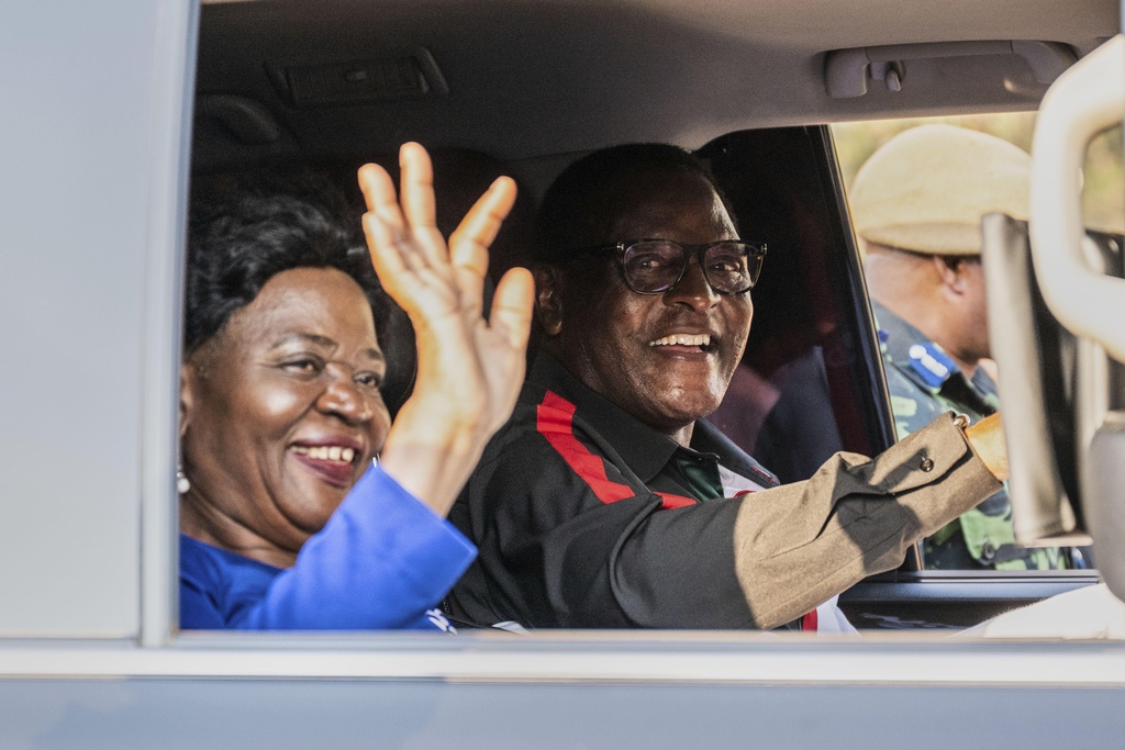Malawi President Lazarus Chakwera, right, and his wife wave during a campaign rally in Blantyre, Malawi, Sunday, Sept. 7, 2025. (AP Photo/Thoko Chikondi)