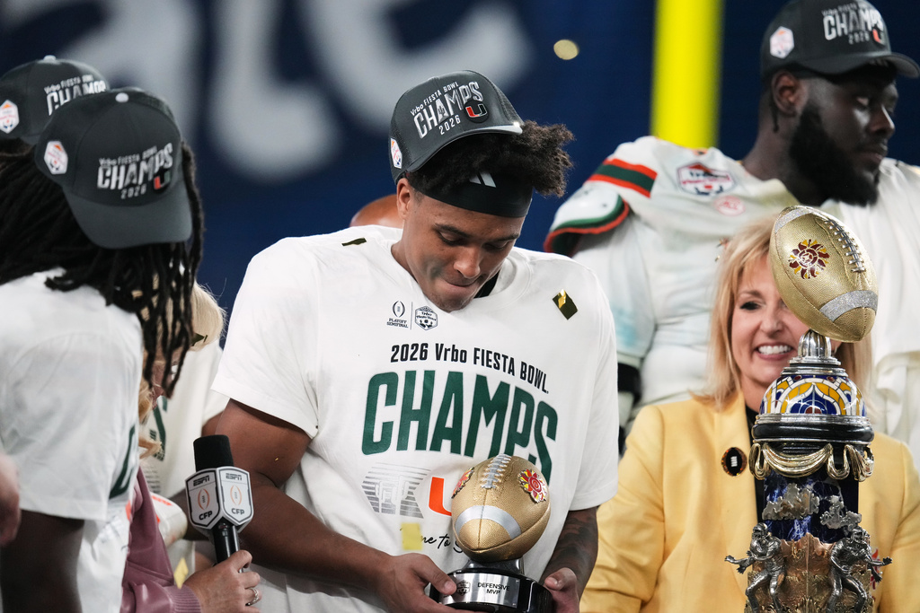 Miami defensive back Jakobe Thomas holds the defensive player of the game trophy after the Fiesta Bowl NCAA college football playoff semifinal game against Mississippi, Thursday, Jan. 8, 2026, in Glendale, Ariz. (AP Photo/Ross D. Franklin)