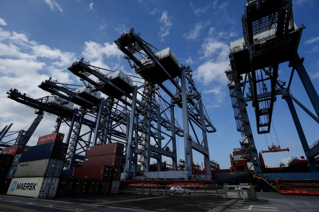 Cranes load and unload containers from cargo ships at the Panama Canal Balboa port in Panama City, Thursday, April 9, 2026. (AP Photo/Matias Delacroix)