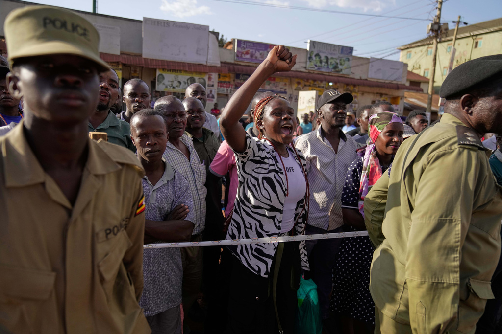 A supporter of leading opposition candidate Bobi Wine cheers while watching election officials count ballots, after polls closed at a polling station in Kampala, Uganda, Thursday, Jan. 15, 2026. (AP Photo/Brian Inganga)