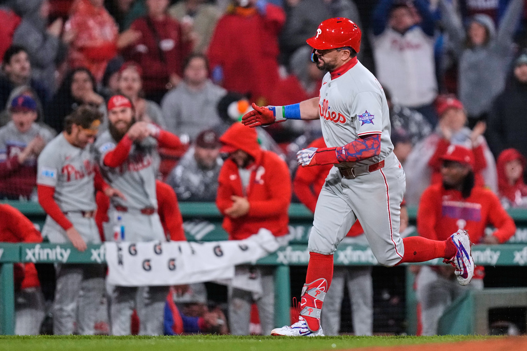 Philadelphia Phillies' Kyle Schwarber celebrates while rounding the bases on his two-run home run during the eighth inning of a baseball game against the Boston Red Sox, Thursday, May 14, 2026, in Boston. (AP Photo/Charles Krupa)