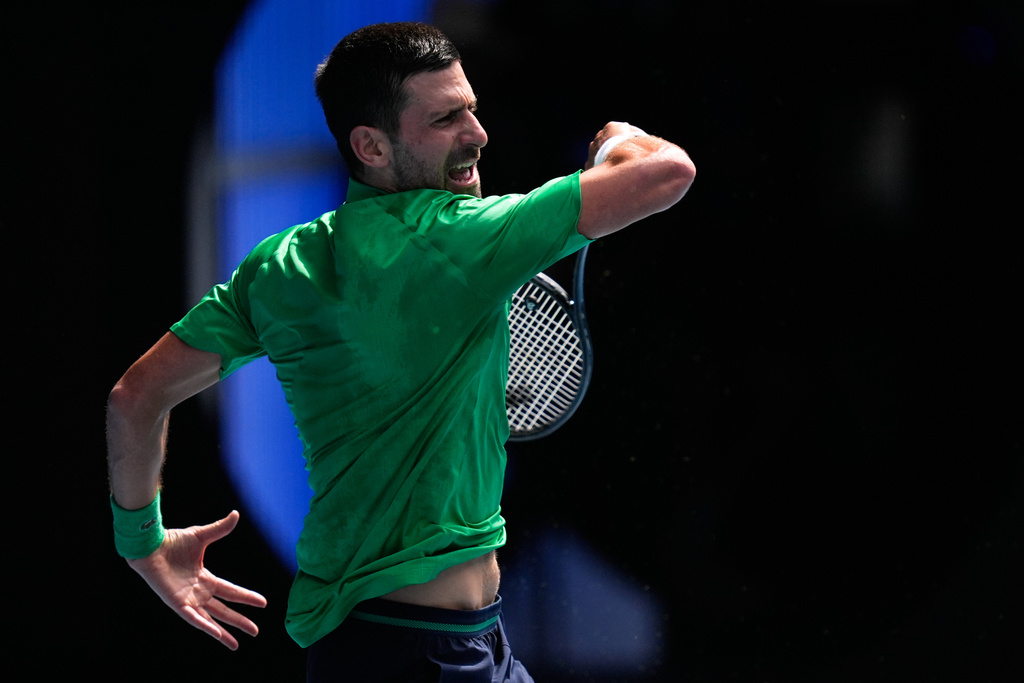 Novak Djokovic of Serbia plays a forehand return to Lorenzo Musetti of Italy during their quarterfinal match at the Australian Open tennis championship in Melbourne, Australia, Wednesday, Jan. 28, 2026. (AP Photo/Asanka Brendon Ratnayake)