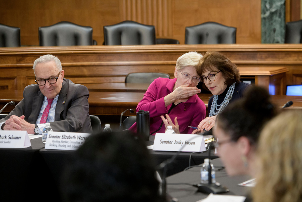 Senate Minority Leader Charles Schumer, D-N.Y., left, sits at left as Sen. Elizabeth Warren, D-Mass., center, talks with Sen. Jacky Rosen, D-Nev., during a round table discussion on the high cost of housing, on Capitol Hill, Wednesday, Jan. 7, 2026, in Washington. (AP Photo/Rod Lamkey, Jr.)