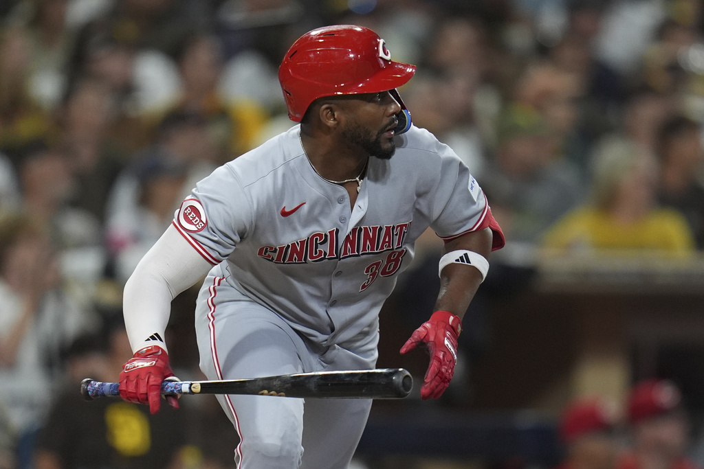 Cincinnati Reds' Miguel Andujar watches his RBI single during the eighth inning of a baseball game against the San Diego Padres Wednesday, Sept. 10, 2025, in San Diego. (AP Photo/Gregory Bull)