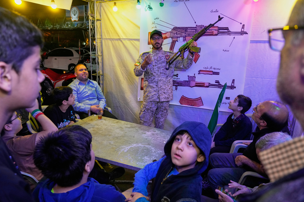 A member of the Revolutionary Guard's volunteer Basij force demonstrates how to handle a Kalashnikov-style assault rifle during a weapons training class in Tehran, Iran, Tuesday, May 19, 2026. (AP Photo/Vahid Salemi)