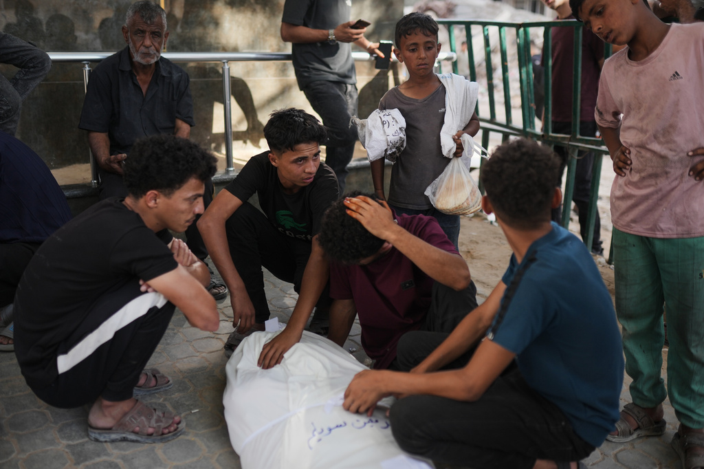 Mourners gather around the bodies of Palestinians killed in an Israeli strike, during their funeral in Shifa Hospital in Gaza City, Sunday, June 14, 2026. (AP Photo/Jehad Alshrafi)