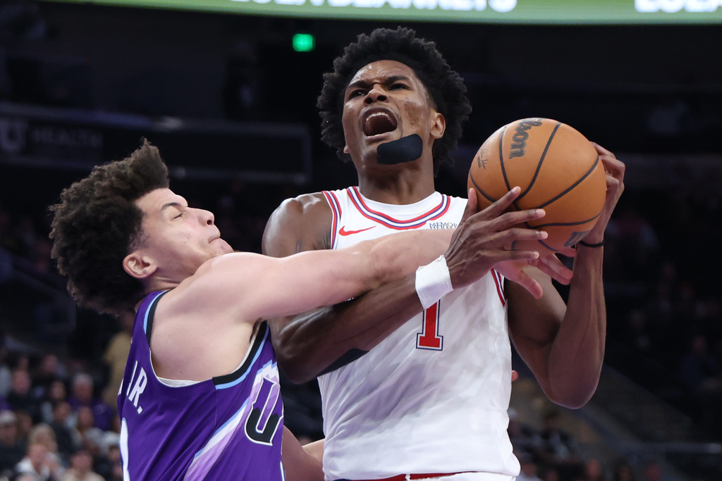 Utah Jazz guard Walter Clayton Jr. left, fouls Houston Rockets guard Amen Thompson, right, during the second half of an NBA basketball game Monday, Dec. 1, 2025, in Salt Lake City. (AP Photo/Rob Gray)