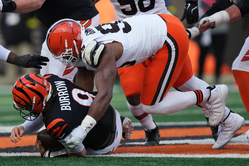 Cleveland Browns defensive end Myles Garrett, top, sacks Cincinnati Bengals quarterback Joe Burrow (9) to set an NFL record for sacks in the regular season during the second half of an NFL football game, Sunday, Jan. 4, 2026, in Cincinnati. (AP Photo/Joshua A. Bickel)