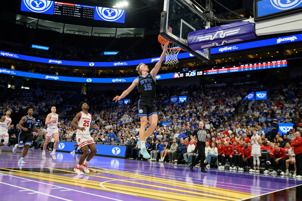 BYU guard Richie Saunders (15) lays the ball into the basket during the first half of an NCAA college basketball game against Wisconsin, Friday, Nov. 21, 2025, in Salt Lake City. (AP Photo/Tyler Tate)