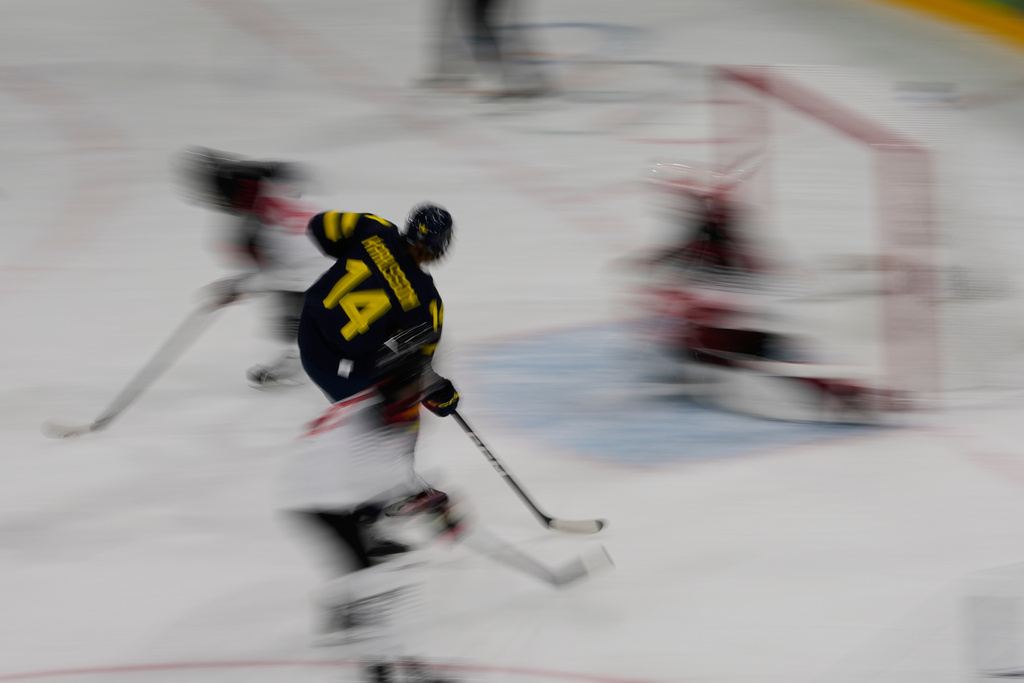 Sweden's Ida Karlsson shoots on goal during a preliminary round match of women's ice hockey between Japan and Sweden at the 2026 Winter Olympics, in Milan, Italy, Tuesday, Feb. 10, 2026. (AP Photo/Hassan Ammar)