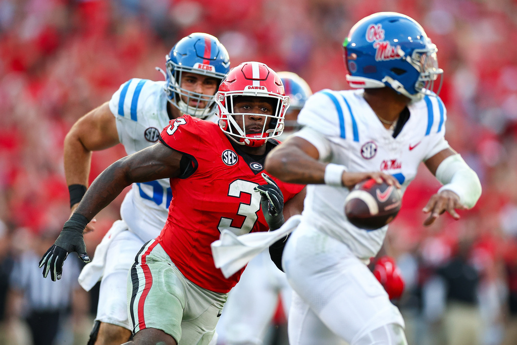 FILE - Georgia linebacker CJ Allen (3) chases Mississippi quarterback Trinidad Chambliss, right, during the second half of an NCAA college football game, Saturday, Oct. 18, 2025, in Athens, Ga. (AP Photo/Colin Hubbard, File)