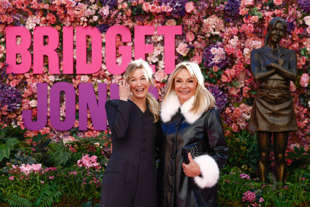Renee Zellweger, left, and writer Helen Fielding pose for photographers during the unveiling of the Bridget Jones statue in Leicester Square, London, Monday, Nov. 17, 2025. (Photo by Millie Turner/Invision/AP)