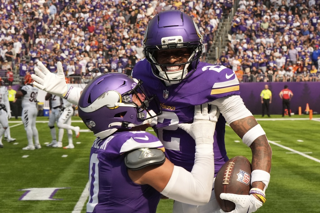 Minnesota Vikings cornerback Isaiah Rodgers (2) celebrates his touchdown with linebacker Ivan Pace Jr. during the first half of an NFL football game against the Cincinnati Bengals, Sunday, Sept. 21, 2025, in Minneapolis. (AP Photo/Mike Stewart)
