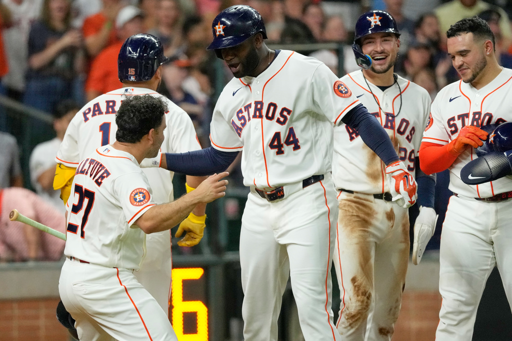 Houston Astros' Yordan Alvarez (44) celebrates with Jose Altuve (27) after hitting a grand slam against the Minnesota Twins during the fourth inning of a baseball game Tuesday, June 30, 2026, in Houston. (AP Photo/David J. Phillip)