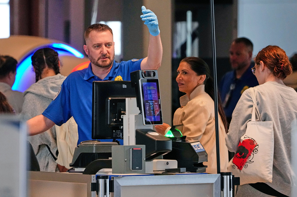 A TSA agent checks passengers at the security checkpoint in Pittsburgh International Airport Monday, March 30, 2026. (AP Photo/Gene J. Puskar)