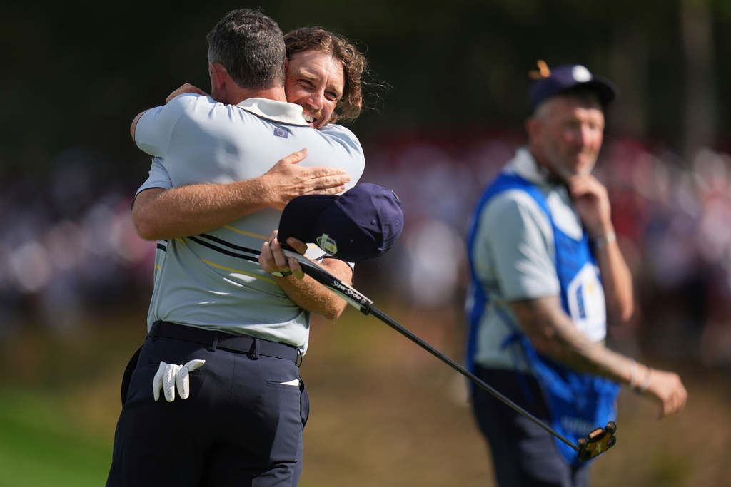 Europe's Tommy Fleetwood and Rory McIlroy celebrate their win on the 14th hole at Bethpage Black golf course during the Ryder Cup golf tournament, Friday, Sept. 26, 2025, in Farmingdale, N.Y. (AP Photo/Seth Wenig)