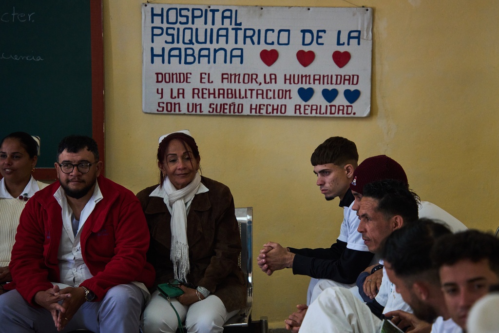 Medical staff, left, and people in rehabilitation, right, sit at a psychiatric hospital in Havana, Cuba, Wednesday, Feb. 25, 2026. (AP Photo/Ramon Espinosa)