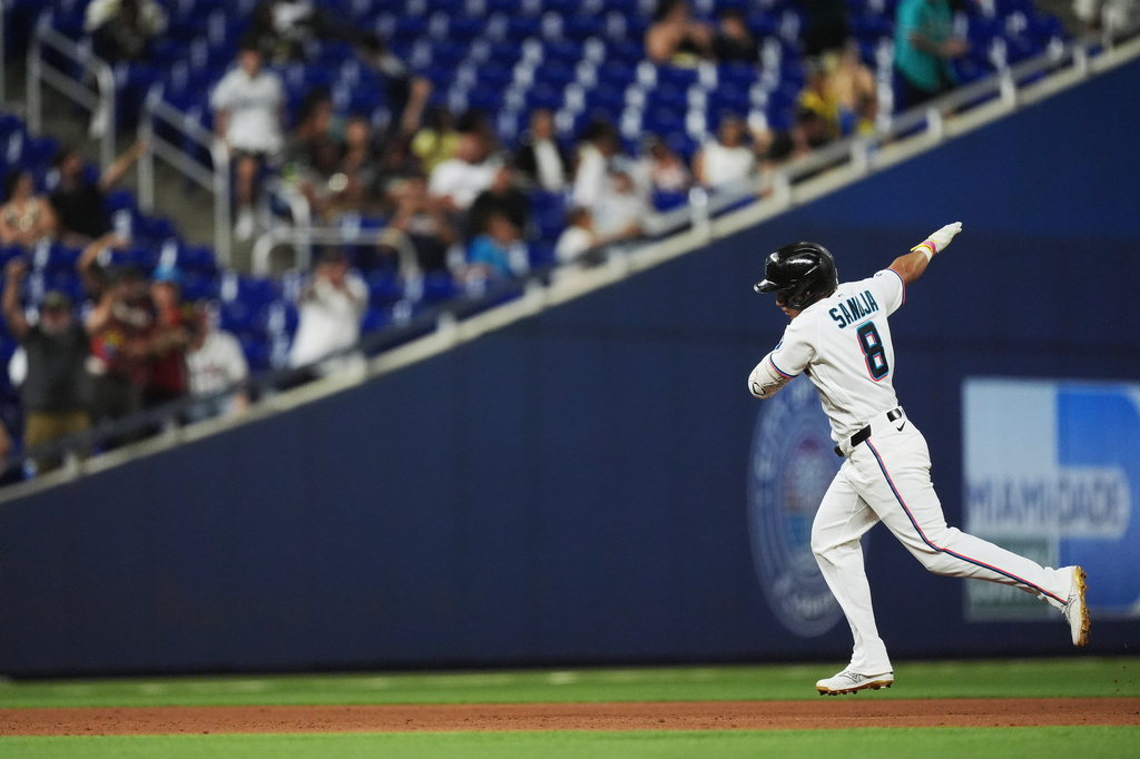 Miami Marlins' Javier Sanoja celebrates as he runs the bases after hitting a grand slam to bring home Jakob Marsee, Connor Norby, and Joe Mack, during the fifth inning of a baseball game against the Atlanta Braves, Monday, May 18, 2026, in Miami. (AP Photo/Rebecca Blackwell)