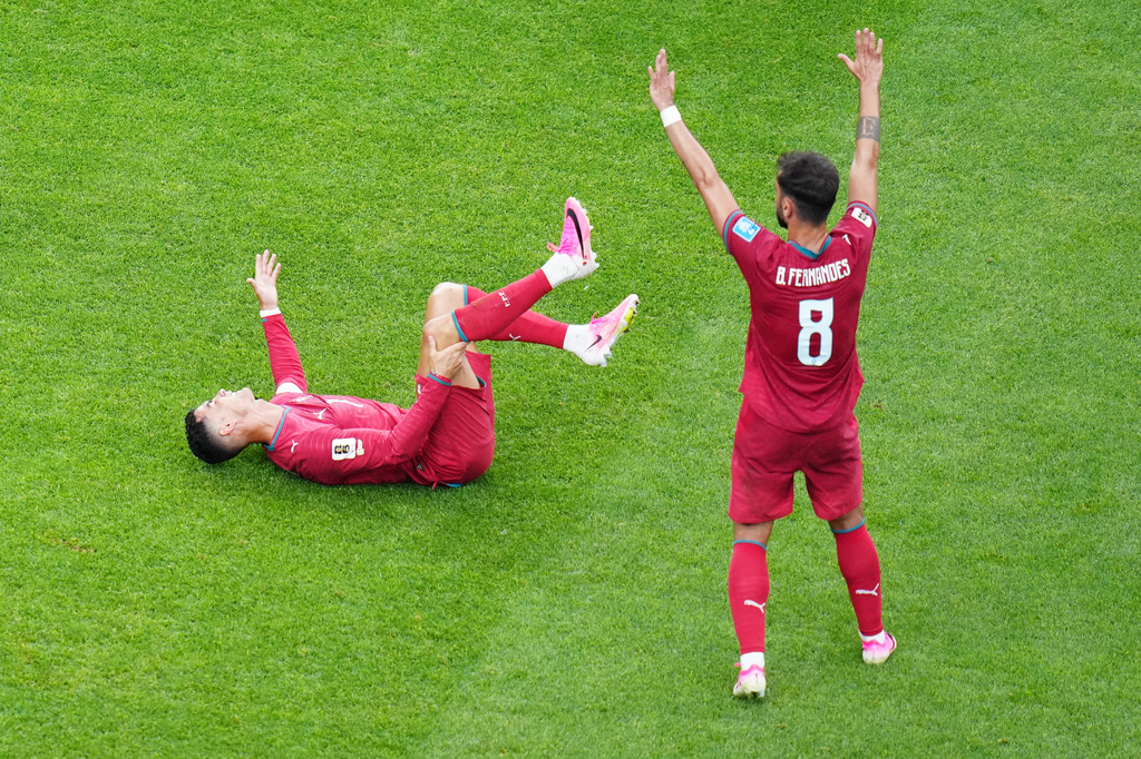 Portugal's Cristiano Ronaldo (7) reacts on the ground near Portugal's Bruno Fernandes (8) during the World Cup Group K soccer match between Portugal and Uzbekistan in Houston, Tuesday, June 23, 2026. (AP Photo/Karen Warren)