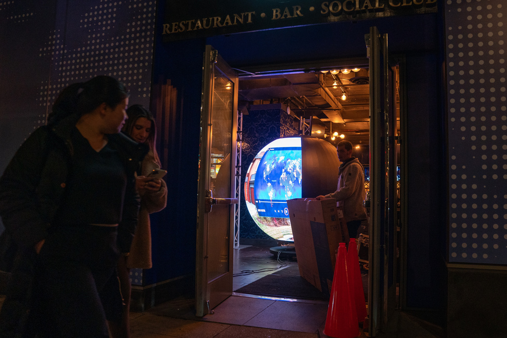 A crew assembles the Polymarket 'Situation Room' pop-up bar at Proper 21 on K Street, Thursday, March 19, 2026, in Washington. (AP Photo/Allison Robbert)