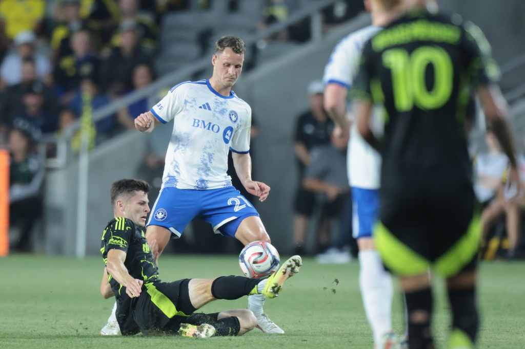 Columbus Crew Midfielder Sean Zawadzki, left, blocks a pass in front of CF Montreal midfield Fabian Herbers during the first of an MLS soccer match in Columbus, Ohio, Wednesday, Aug. 19, 2026. (AP Photo/Paul Vernon)