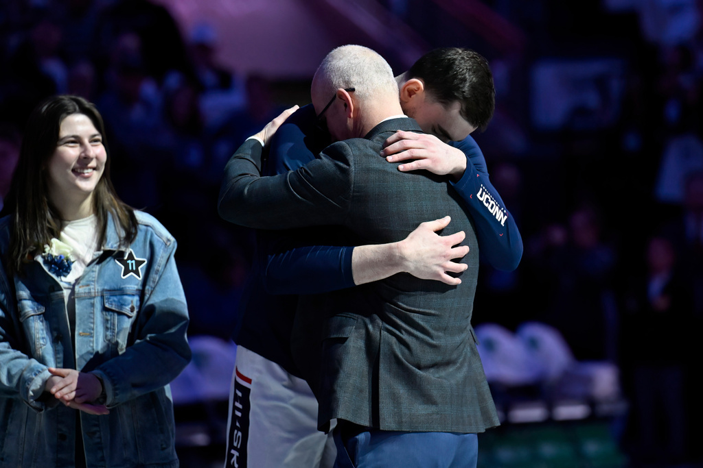 UConn head coach Dan Hurley, right, embraces UConn forward Alex Karaban during a pregame ceremony adding Karaban's name and number to the Huskies of Honor before an NCAA college basketball game between UConn and Seton Hall, Saturday, Feb. 28, 2026, in Storrs, Conn. (AP Photo/Jessica Hill)