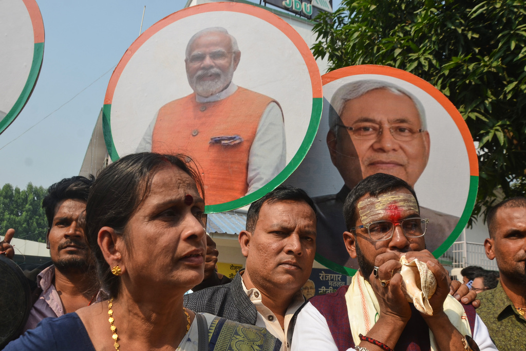 Supporters of National Demoractic Alliance (NDA) celebrate the early leads in Bihar state election results in front of the photographs of their leaders Nitish Kumar of Janata Dal (United), right, and Prime Minister Narendra Modi of Bharaiya Janata party, center, in Patna, India, Friday, Nov.14, 2025. (AP Photo)