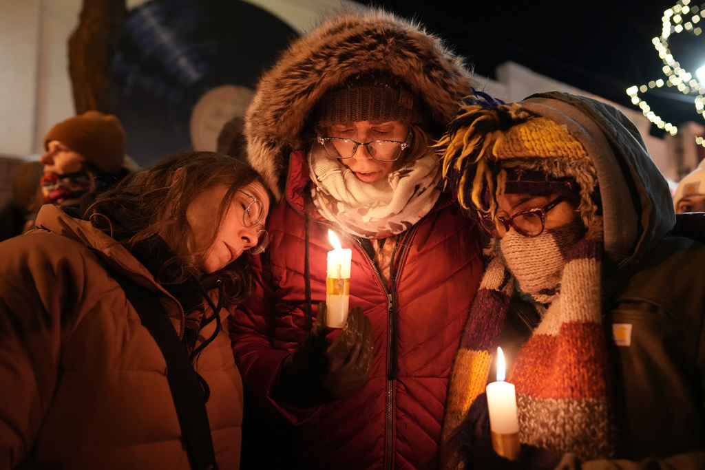 People attend a vigil where Alex Pretti was shot and killed by federal immigration enforcement in Minneapolis, on Wednesday, Jan. 28, 2026. (AP Photo/Adam Gray)