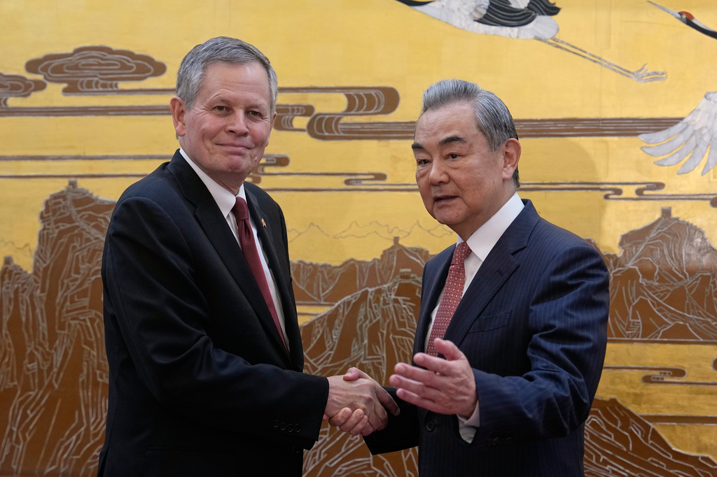 U.S. Senator Steve Daines, left, is greeted by Chinese Foreign Minister Wang Yi during a U.S. congressional delegation visit at the Great Hall of the People, in Beijing, Thursday, May 7, 2026. (AP Photo/Andy Wong, Pool)