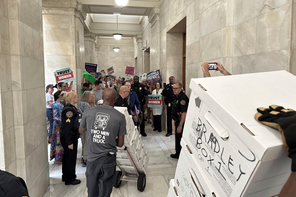 FILE - Boxes containing signatures supporting a proposed ballot measure to scale back Arkansas' abortion ban are delivered to a room in the state Capitol, July 5, 2024, in Little Rock, Ark. (AP Photo/Andrew DeMillo, File)