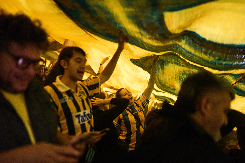 Atlanta fans chant slogans under a flag during an Argentine second-division soccer match against Chacarita Juniors, in Buenos Aires, Argentina, Monday, April 20, 2026. (AP Photo/Rodrigo Abd)