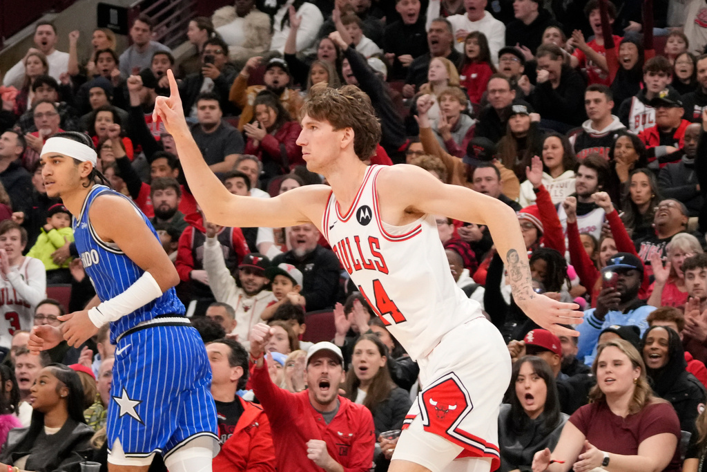 Chicago Bulls forward Matas Buzelis, right, gestures after making a 3-point basket over Orlando Magic guard Anthony Black, left, during the second half of an NBA basketball game, Friday, Jan. 2, 2026, in Chicago. (AP Photo/David Banks)