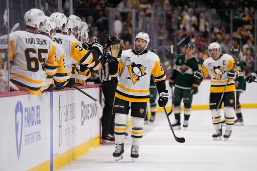 Pittsburgh Penguins right wing Bryan Rust (17) celebrates with teammates after scoring a goal during the third period of an NHL hockey game against the Minnesota Wild, Thursday, Oct. 30, 2025, in St. Paul, Minn. (AP Photo/Abbie Parr) Pittsburgh Penguins right wing Bryan Rust (17) celebrates with teammates after scoring a goal during the third period of an NHL hockey game against the Minnesota Wild, Thursday, Oct. 30, 2025, in St. Paul, Minn. (AP Photo/Abbie Parr)