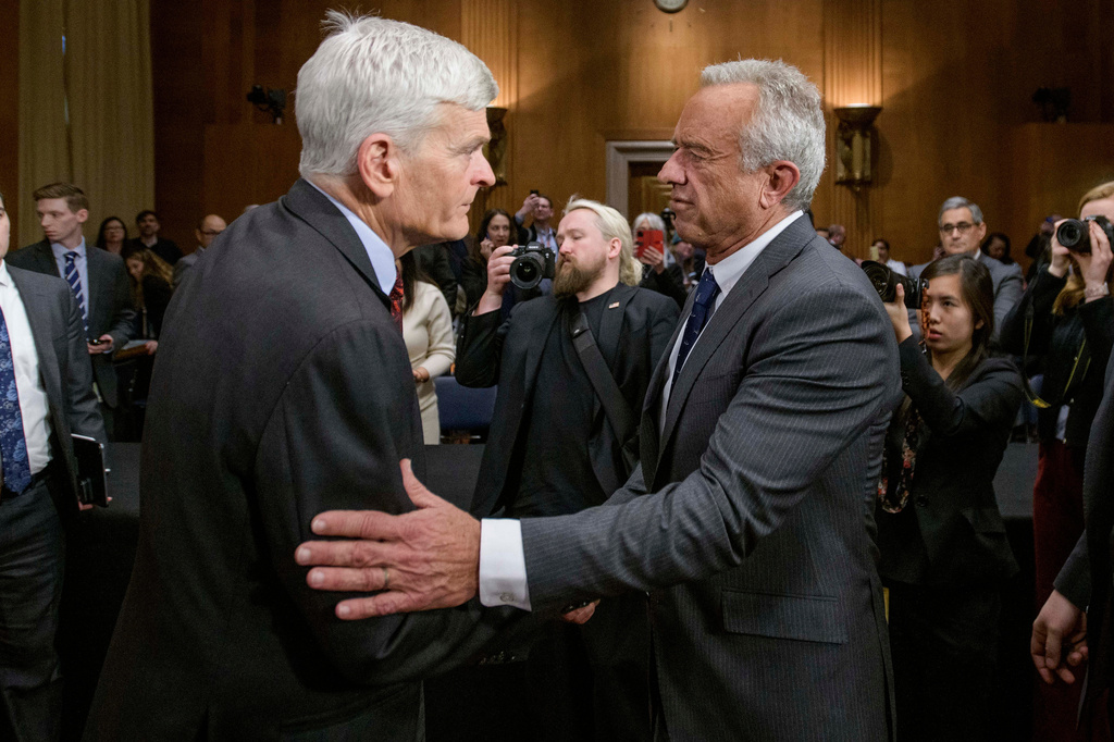FILE - Robert F. Kennedy, Jr., right, President Donald Trump's nominee to serve as Secretary of Health and Human Services, talks with Committee Chairman Sen. Bill Cassidy, R-La., following his confirmation hearing on Capitol Hill, Jan. 30, 2025, in Washington. (AP Photo/Rod Lamkey, Jr., File)